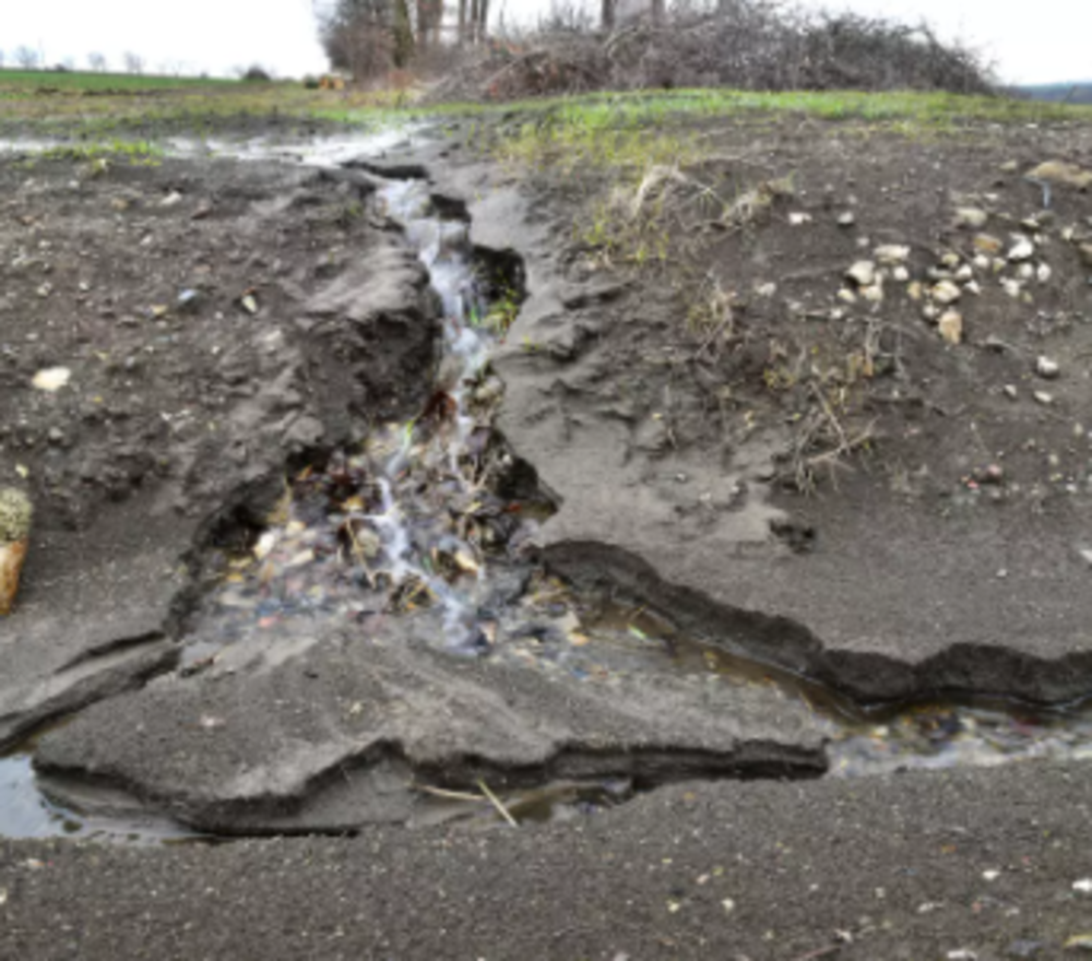 Image of erosion due to drainage problems.
