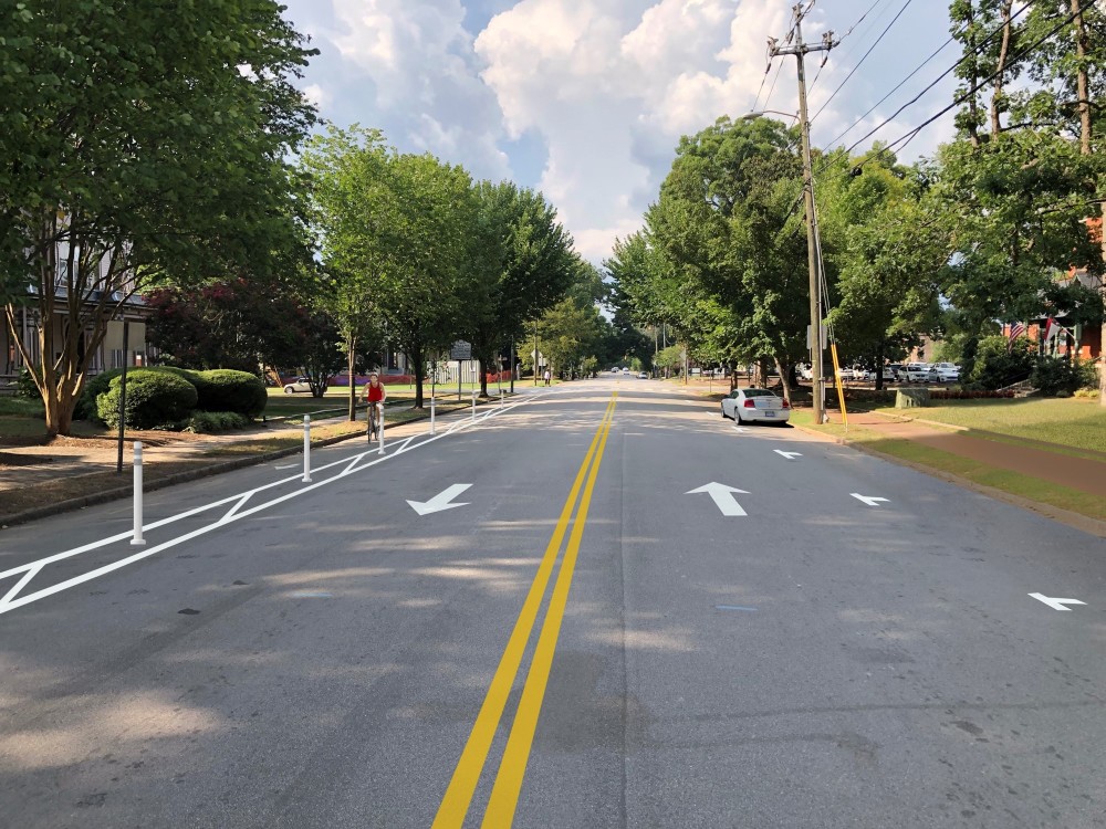 photo rendering of what Blount Street will look like with buffered bike lanes. This images is looking north on Blount Street with bike lanes shown with bike in lane.