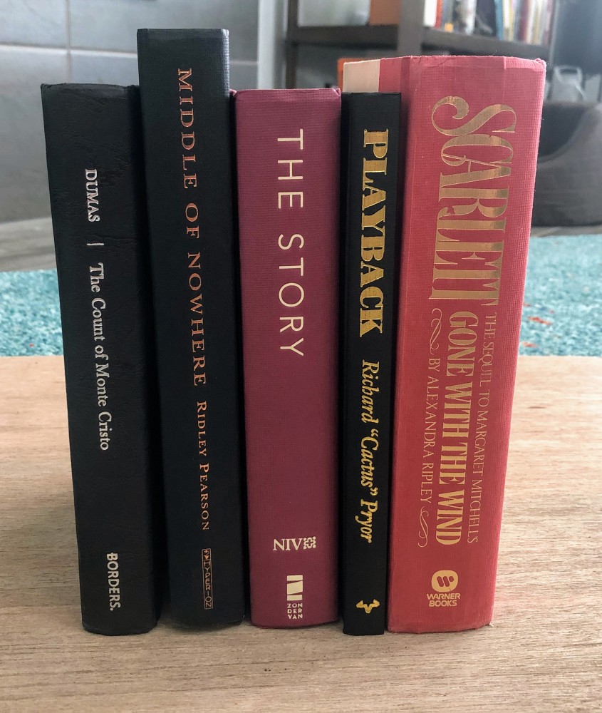 Five hardcover books side-by-side