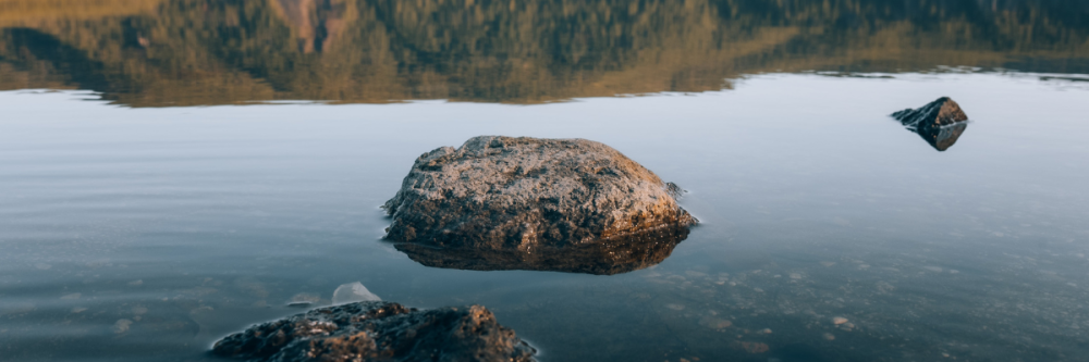 Lake with mountain in background and rocks