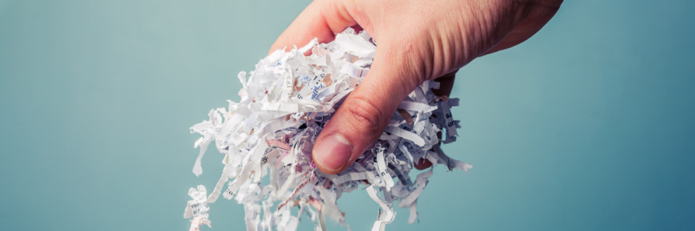 hand-dropping-shredded-paper
