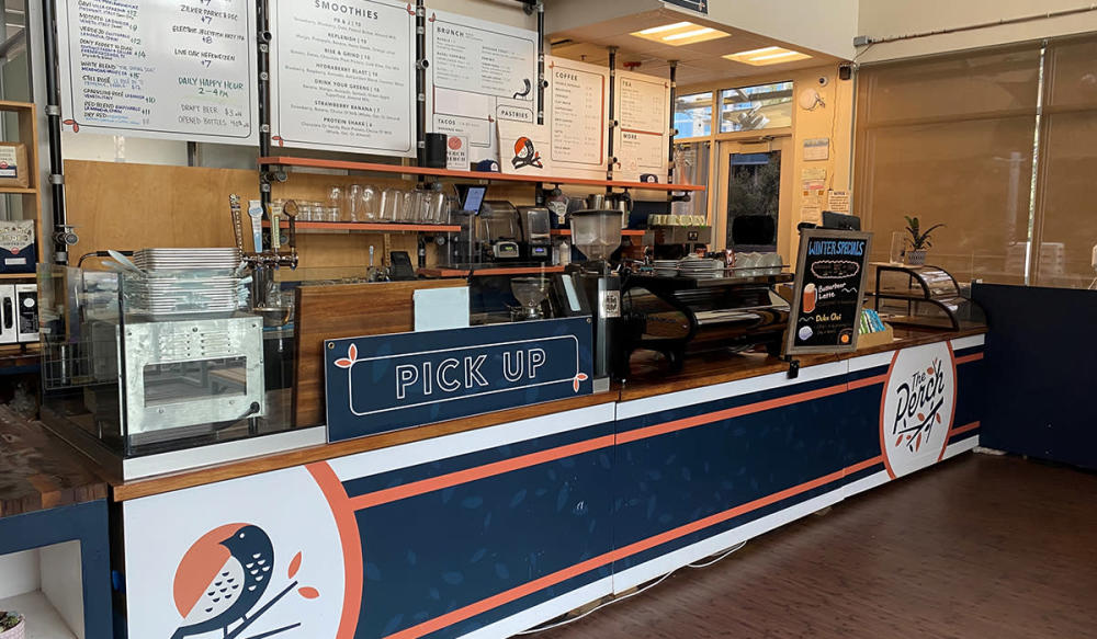 Image of the counter at The Perch showing menu in background and coffee machine