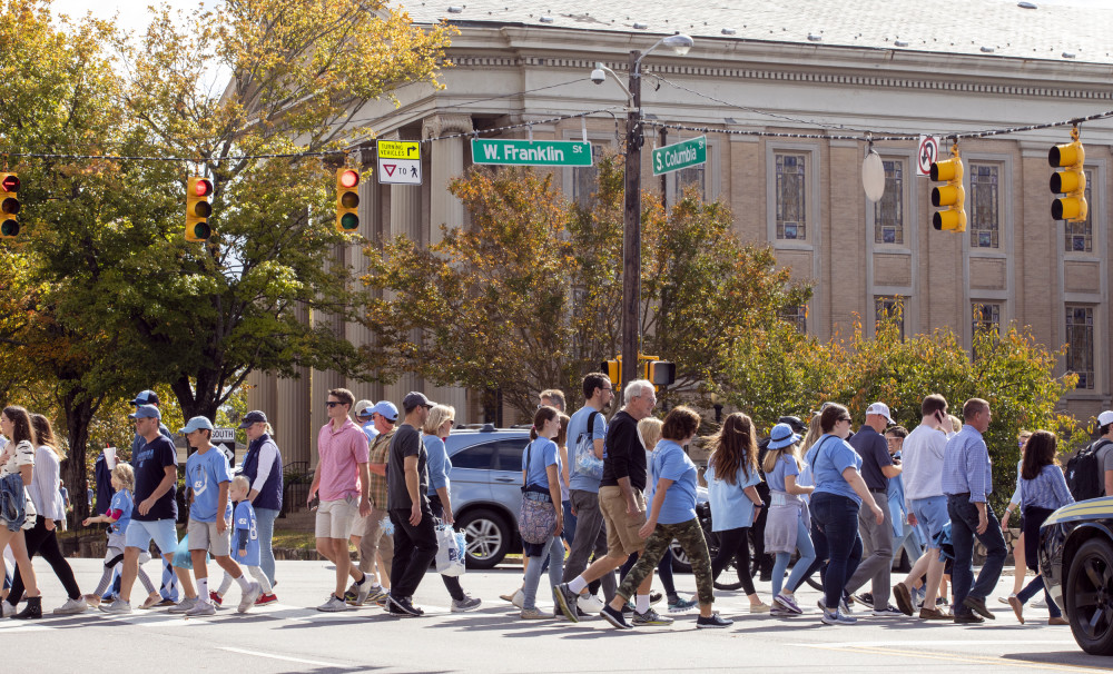 Visitors in Downtown Chapel Hill cross North Columbia and Franklin St intersection on UNC gameday