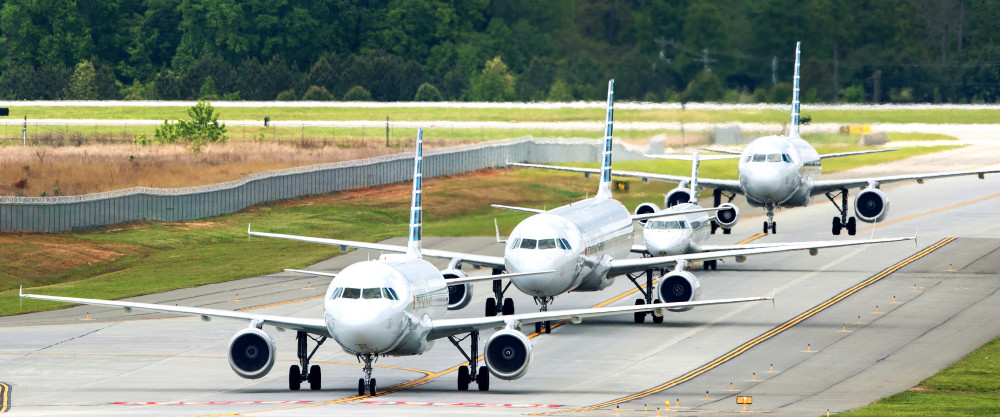 Four aircraft line up on the CLT runway preparing for takeoff
