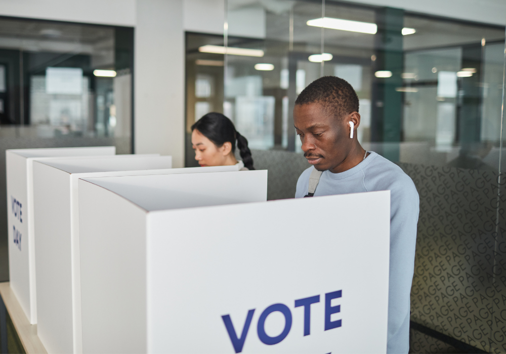Two people casting their votes
