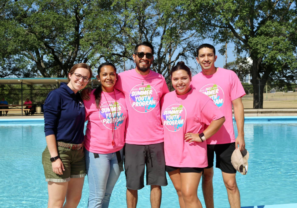 Parks and Recreation summer staff smiling near pool