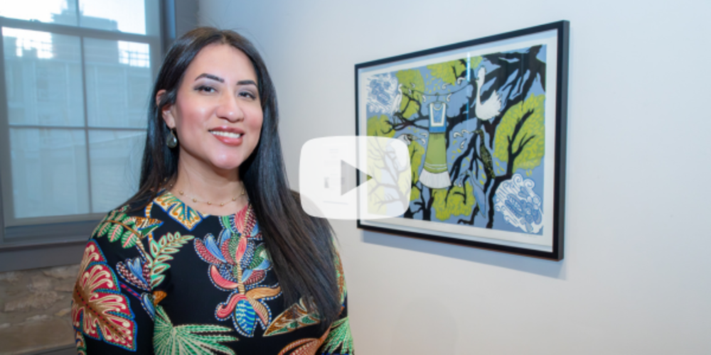 Video screenshot of Artist Celeste De Luna in front of artwork