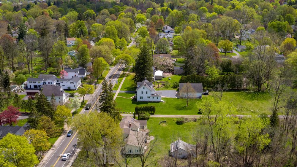 aerial image of Village of Fairport depicting green trees, grass, streets and buildings