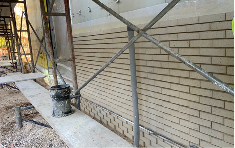 Mock-up: Textured brick installation for review and inspection.