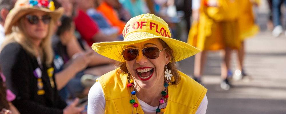 A Woman laughing in fiesta attire in market square