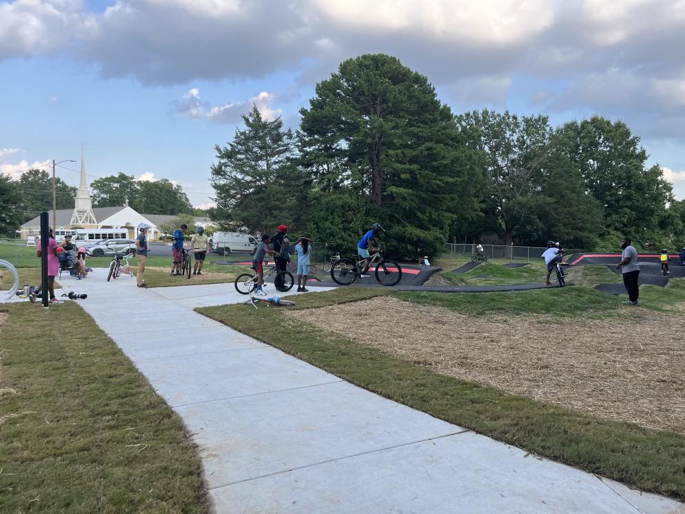 People waiting to use pump track at Fred Alexander Park opening.