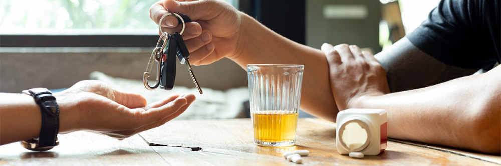 person-with-pills-and-alcohol-hands-over-car-keys