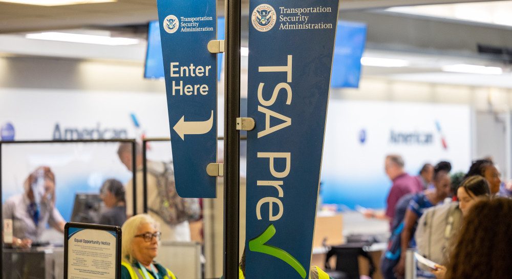Signage shows TSA PreCheck line in the airport terminal