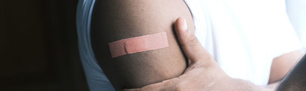 Close-up of a bandaid on someone's arm