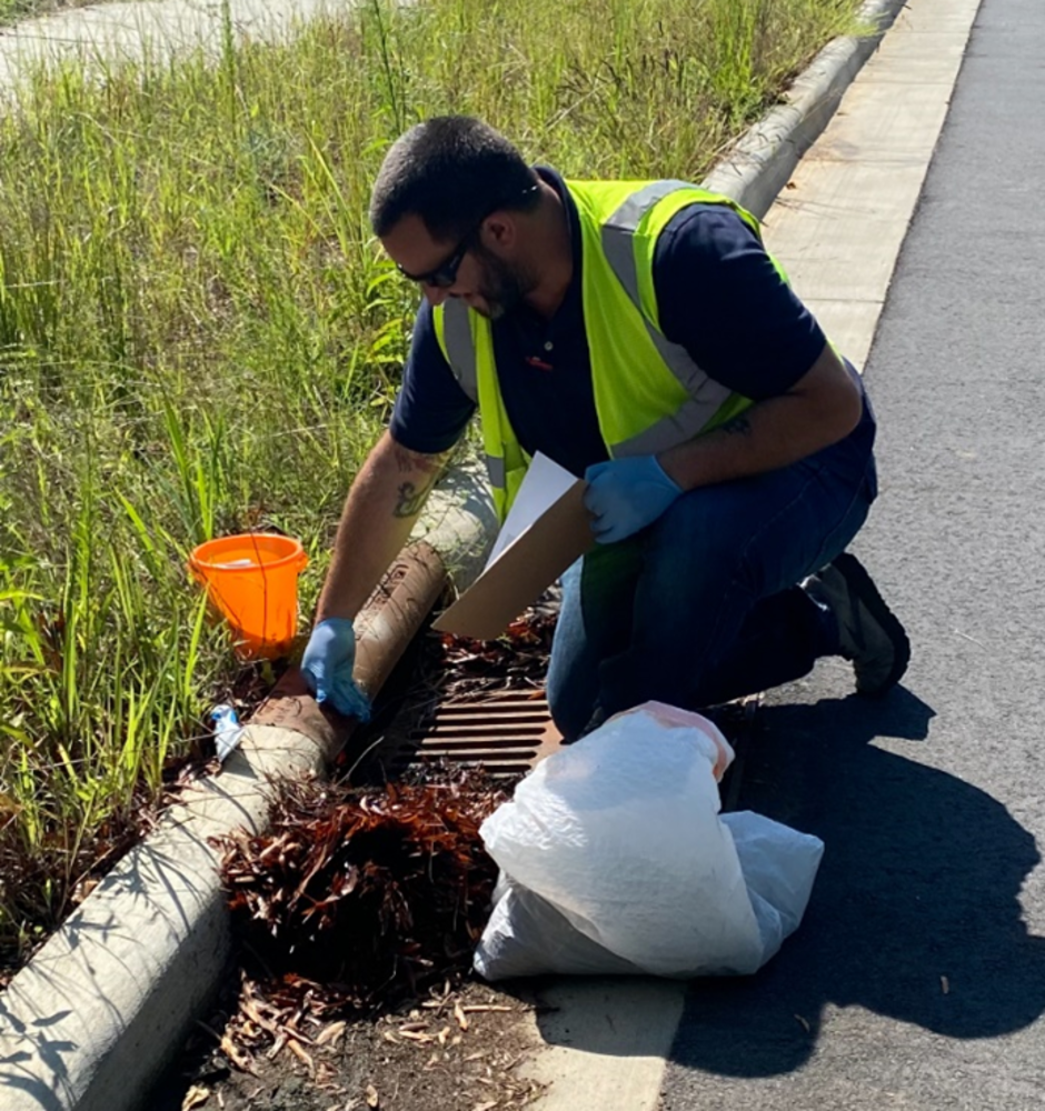 Volunteer Cleaning Drain.