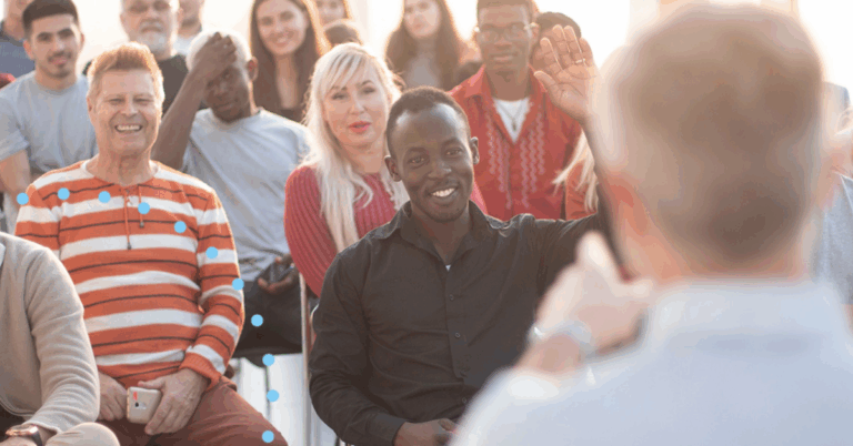Man raising his land in audience