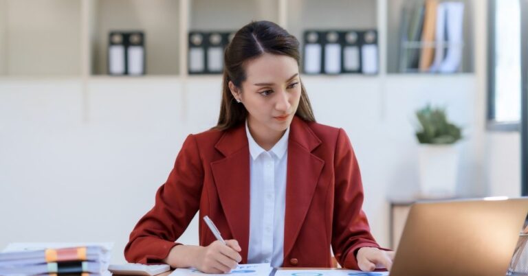 Women sitting at desk in front of a computer