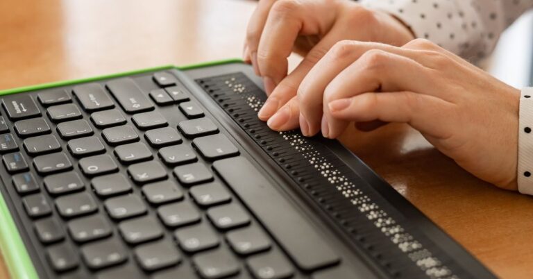 Person typing on a braille keyboard
