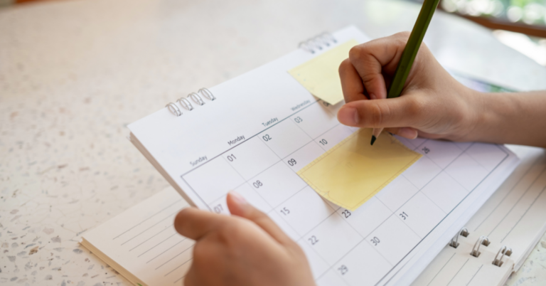 Person filling out calendar
