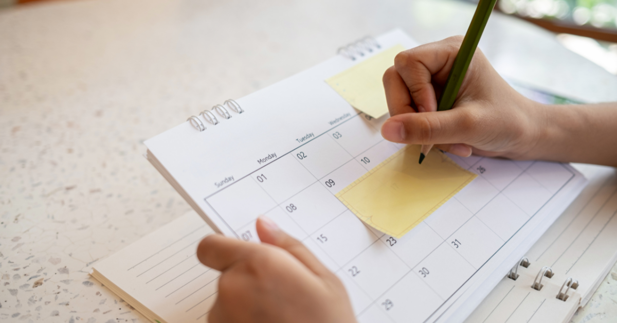 Person filling out calendar